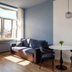 Cozy hotel room at MIRO Rooms, featuring a relaxing sofa and dining table.