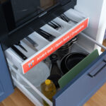 Kitchen amenities at MIRO Rooms in Riga: utensils, plates, and cooking tools.